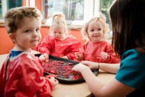 Children playing with jelly in nursery