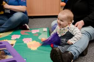 Baby playing in Flying Start Language and Play Session