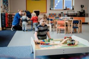 Boy playing with train in afterschool club