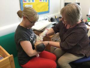 Demonstrating breastfeeding with mum