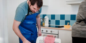 Get cooking, man looking at recipe book
