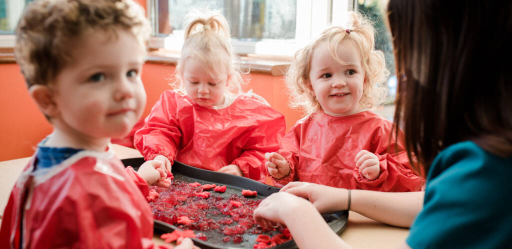 Children in aprons making food